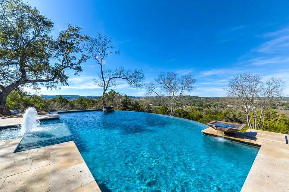 Blue pool with a vanishing edge overlooking the Texas Hill Country